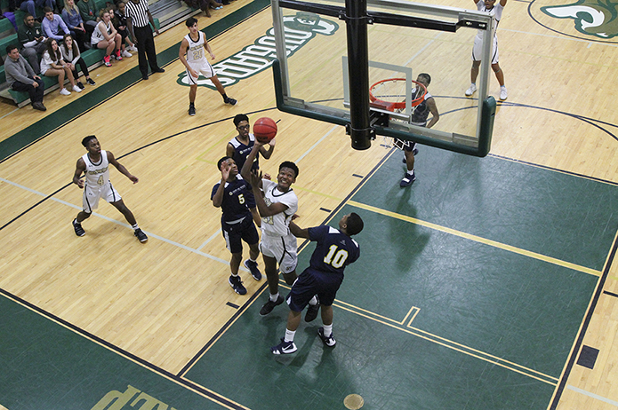 Holy Spirit Prep forward Kusamae Draper (#21) banks the ball off the glass for two points in the closing moments of the game. Photo By Michael Alexander