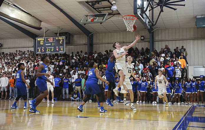 St. Pius X High School senior guard Niko Broadway is fouled with 4.8 seconds remaining in the first period. Broadway converted one of two from the foul line before the period ended. Three points in a single period was a season low for the St. Pius team, as they went on to lose to Americus-Sumter High School 63-46 in the Feb. 27 state basketball quarterfinals. Photo By Michael Alexander