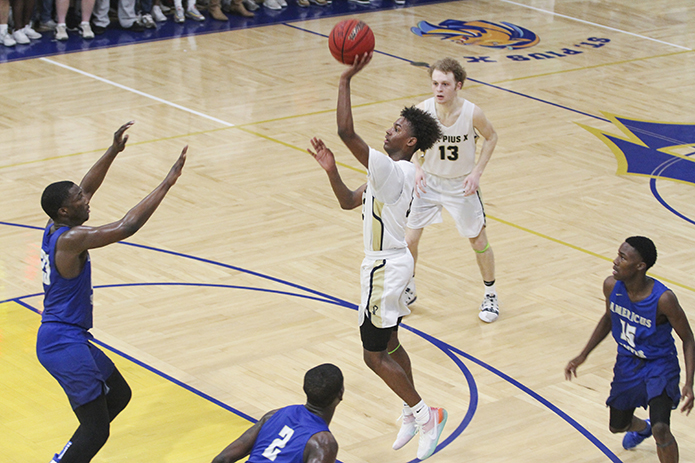 During the second half of the Feb. 27 state basketball quarterfinals, St. Pius X High School freshman guard Chase Cormier shoots a “floater” over the defense. Cormier led his team in scoring with 11 points in the 63-46 loss to Americus-Sumter High School. Photo By Michael Alexander