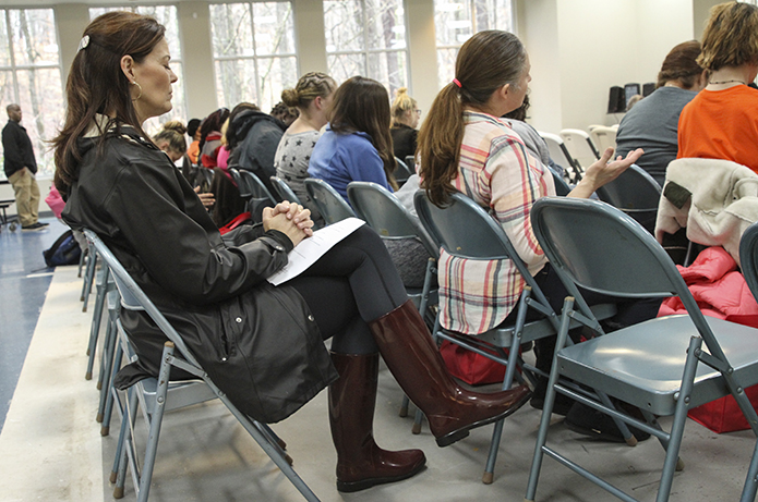 Cathy Lefar, back row, black coat, prays with others during the Feb. 22 prayer vigil at Rivercliff Lutheran Church, Sandy Springs. Lefar is a volunteer and mentor at Mary Hall Freedom House. Photo By Michael Alexander