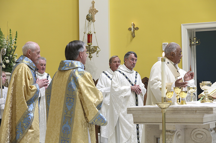 During the Liturgy of the Eucharist, Father Darragh Griffith, second from left, the current pastor of Mary Our Queen Church, Peachtree Corners, Father David M. Dye, second from right, senior priest and former administrator of Mary Our Queen Church, and Father Francis âButchâ Mazur, third from right, the last pastor of St. Gerard Church, Buffalo, New York, join their brother clergy on the altar, including Archbishop Wilton D. Gregory, right, the principal celebrant. Photo By Michael Alexander