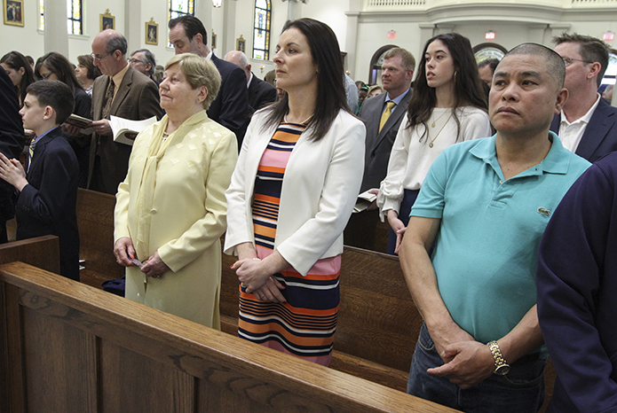 Angela Griffith, left center, the mother of Father Darragh Griffith, and his sister Ann Marie Watkin, right center, came from Dublin, Ireland to attend the Mass of Dedication on St. Patrick's Day. Photo By Michael Alexander