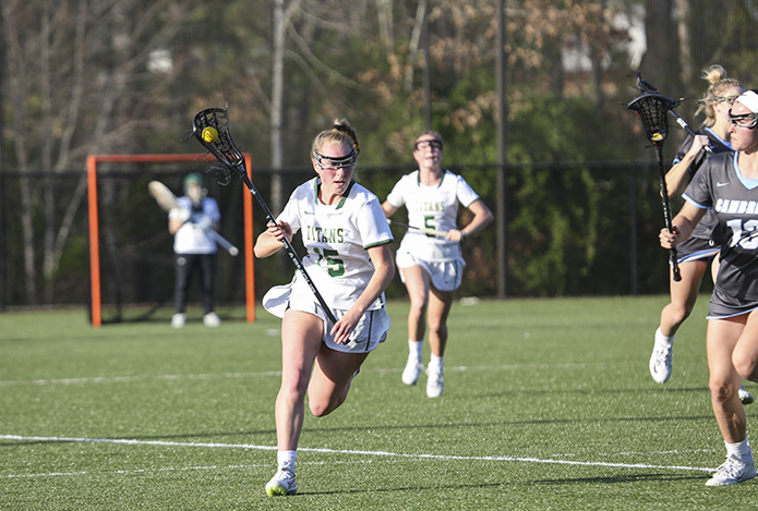 Blessed Trinity midfielder Abbey Sokol (#15) uses her speed to outrun her Cambridge High School opponents during the match's first half. Photo By Michael Alexander