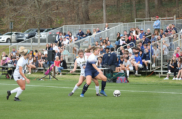 Caroline Ross, right center, the team captain for Marist School, tries to keep the ball away from St. Pius X defender Laney Polvino (#17), left center. Photo By Michael Alexander