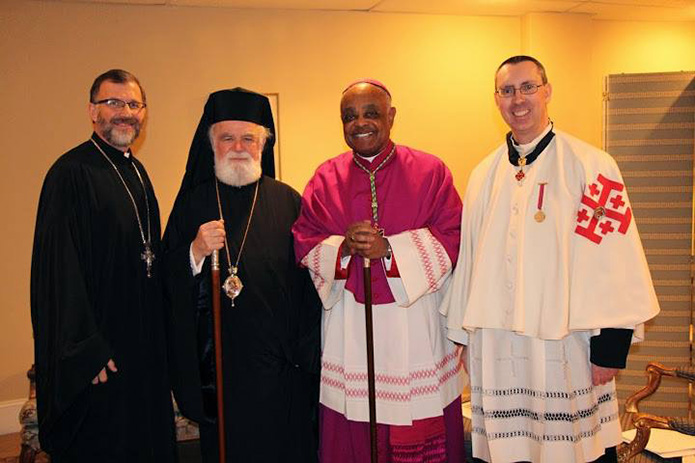 During one of the bi-annual Catholic-Orthodox ecumenical gatherings, Archbishop Gregory stands with, from left, Father George Tsahakis, chancellor, Greek Orthodox Metropolis of Atlanta, His Eminence Metropolitan Alexios and Father Paul Burke from the Archdiocese of Atlanta.