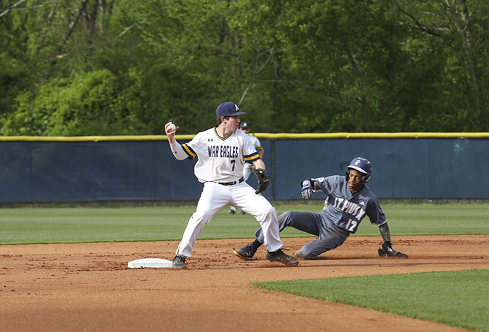 Marist School second baseman Matthew McDermond (#7) touches the bag before St. Pius X High School's Chandler Simpson (#12) can make it to second base. Then McDermond fires the ball down to the first baseman, Liam Sullivan, to successfully turn the double play in the first inning. Marist defeated St. Pius X in the April 11 game 11-0. Photo By Michael Alexander