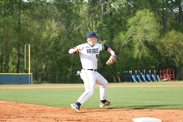 After fielding a ground ball, Marist School third baseman Dean Colton throws the runner out heading to first base. Photo By Michael Alexander