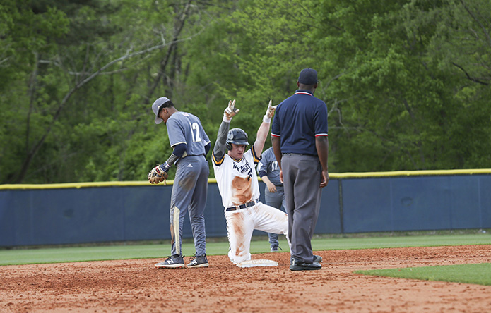 Marist School catcher James MacCallum gestures to the dugout after hitting a double in the fourth inning. Marist would add six more runs in the fourth inning to go out to an 11-0 lead over St. Pius X. That would also turn out to be the final score of the April 11 game. Photo By Michael Alexander