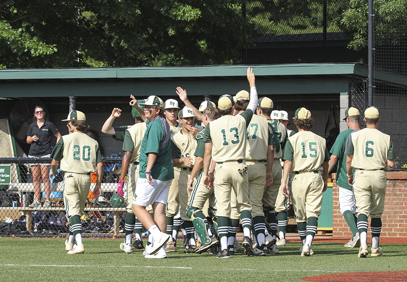 The Blessed Trinity High School players come out of the dugout to celebrate as a run comes across home plate during the third inning to give them their first lead of game oneâs Class AAAA state baseball quarterfinals against College Parkâs Woodward Academy. In the first game of a best two out of three-game series, Blessed Trinity was a 7-2 winner. Photo By Michael Alexander