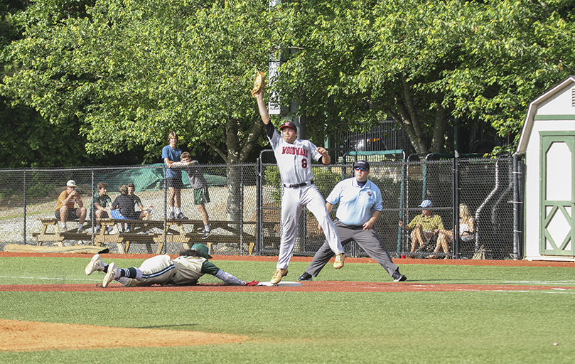 Blessed Trinity's Steele Chambers makes it back to the first base bag, after a pickoff attempt by the Woodward Academy pitcher goes high to the first baseman. Photo By Michael Alexander