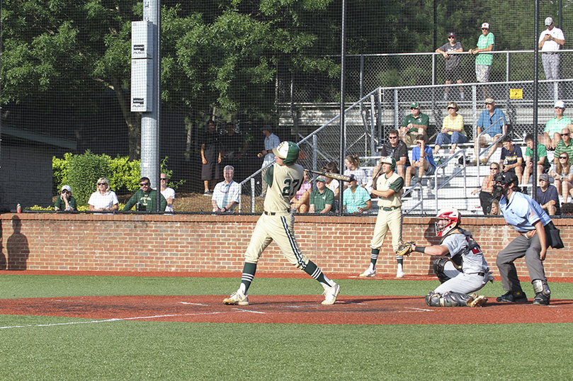 With two outs in the sixth inning, Blessed Trinity High School left fielder Trey Baker (#27) hits a ground rule double deep into the outfield to drive in two runs during the first game of a best two out of three series against Woodward Academy at the Class AAAA state baseball quarterfinals. Blessed Trinity won game one 7-2. Photo By Michael Alexander