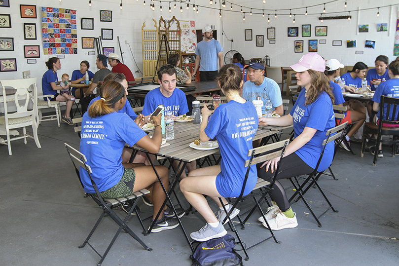 Upon the group's arrival to Refuge Coffee, food awaited them that was catered by Merhaba Shawarma. The Clarkston eatery, featuring Mediterranean cuisine, is owned by a woman who came to United States in 1983 as refugee from Eritrea. Photo By Michael Alexander