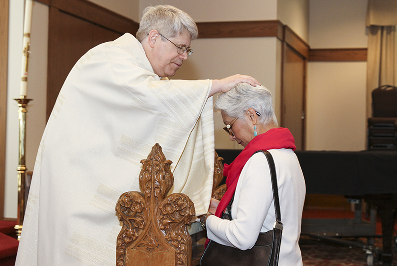 During the reception line in the Cathedral of Christ the King's Kenny Hall, Father Mark White extends a blessing to Alicia Lavisky, a resident of the southeast Michigan town of Clarkston. Father Mark gave his first blessings to Bishop Bernard E. Shlesinger III and Bishop Joel M. Konzen, SM, respectively, in the church during his June 1 ordination to the priesthood. Photo By Michael Alexander