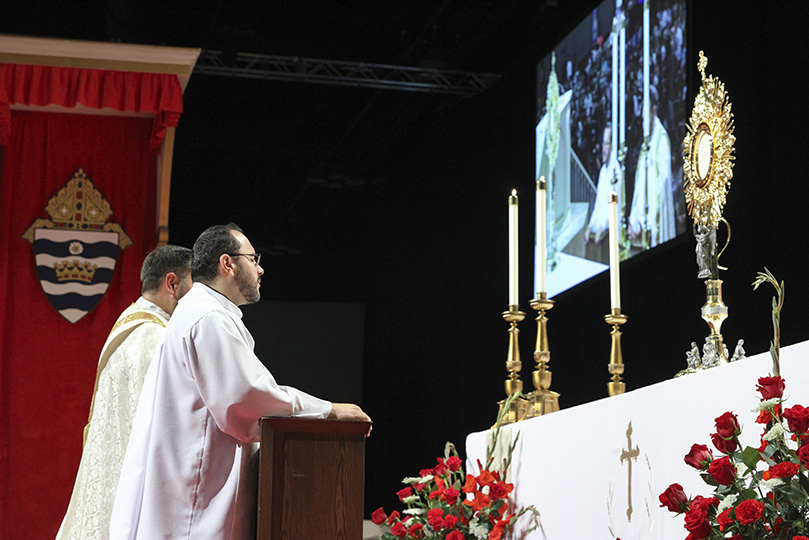 (Front to back) Father Carlos Vargas, pastor of Good Samaritan Church, Ellijay, and Father Michael Silloway, administrator of Christ Our King and Savior Church, Greensboro, pray before the Blessed Sacrament with the congregation. They were co-facilitators and speakers during the healing service, which followed the opening Mass for the Eucharistic Congress. Photo By Michael Alexander