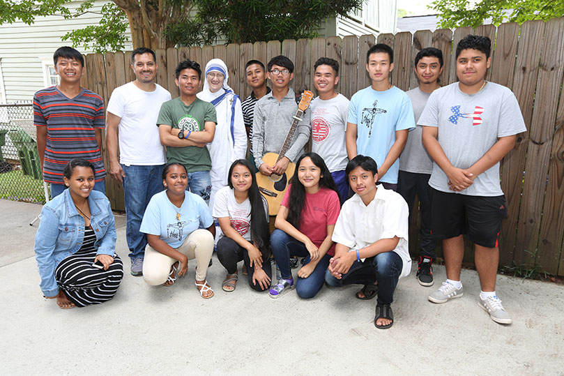 Sister Mary Prema, MC, back row, fourth from left, superior general of the Missionaries of Charity since 2009, poses for a photograph with Gift of Grace House volunteer Lucio Garcia, back row, second from left, and teen volunteers from Corpus Christi Church, Stone Mountain. Photo By Michael Alexander