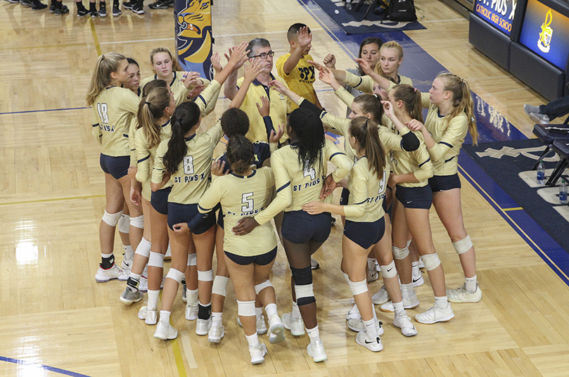 St. Pius X head coach John Frederick brings the team together as they prepare to return to the court after a called timeout. At this point in the third set, St. Pius was winning by one point, but they would lose the set 25-20. St. Pius eventually prevailed over Mount Paran Christian by winning three of the five sets. Photo By Michael Alexander