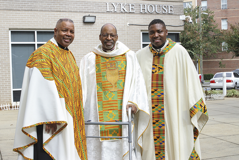 Following Lyke Houseâs 20th anniversary dedication Mass, Msgr. Edward Branch, center, the honored guest during the Oct. 20th Mass, poses for a photograph with the Massâs homilist, Father Chester Smith, SVD, left, and Father Urey Mark, right, the current chaplain and director of Lyke House. Father Mark succeeded Msgr. Branch after his June 2015 retirement. Photo By Michael Alexander