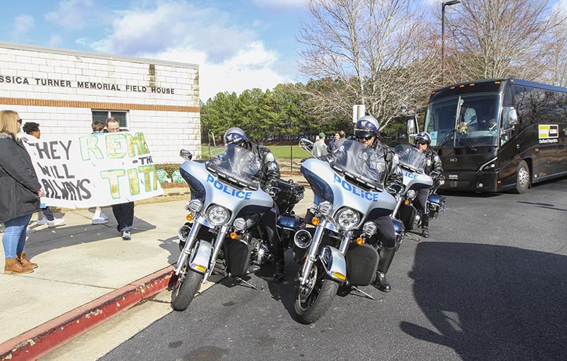 After the football players, coaches and cheerleaders boarded the buses to make the trip to Atlanta for the game, three off-duty motorcycle officers from the Roswell Police Department led a motorcade of team buses from Blessed Trinity High School, down Crossville and Holcombe Bridge Roads, all the way to Georgia State Route 400. Parents and supporters were there to see them off. Photo By Michael Alexander 