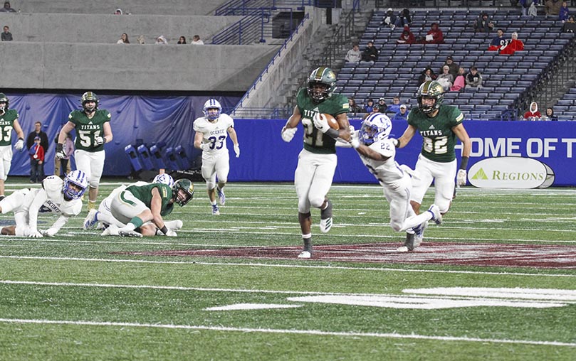 Oconee County cornerback Darius Johnson Jr. (#22) makes a last-ditch effort to bring Green (#21) down from behind to no avail. Photo By Michael Alexander