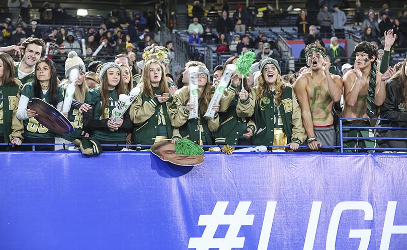 In the student section at Georgia State University Stadium, cheers go up for the Blessed Trinity Titans as they return to the field for the second half of play. Blessed Trinity scored all 17 of its points in the first half, but it was enough to hold off and defeat Oconee County 17-14. Photo By Michael Alexander