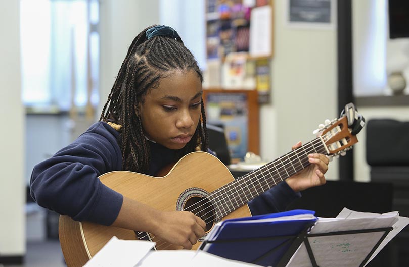 Brianna Harris, a senior in the advanced classical guitar class at St. Pius X High School, rehearses The Nutcraker’s “Overture” with three fellow seniors for the 2019 Christmas concert, which took place December 4-5. Photo By Michael Alexander