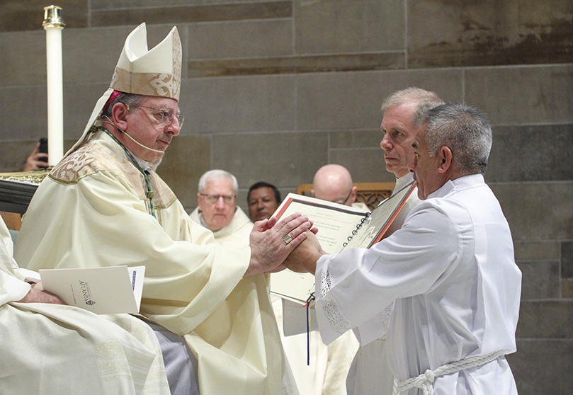 Diaconate ordination candidate David Hernández makes his promise of obedience to Bishop Joel M. Konzen, SM, the diocesan administrator, during the rite of ordination to the permanent diaconate. The Feb. 1 ordination took place at the Cathedral of Christ the King, Atlanta.