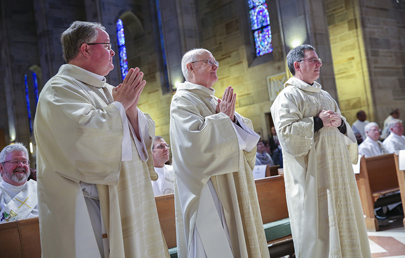 Three of the eight newest deacons, (l-r) William Kester, Joseph Odom Jr. and James Windom prepare to go up on the altar for the Liturgy of the Eucharist. Kester, Odom and Windon are assigned to Our Lady of the Assumption Church, Atlanta, St. John Neumann Church, Lilburn, and St. Philip Benizi Church, Jonesboro, respectively. Photo By Michael Alexander