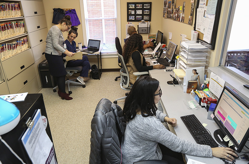 Working in the Forest Park clinic's intake area are (clockwise, from top left) Stefany Malave, clinic manager, Nina Emamifar, RN, sonographer, Judith Ngome, ultrasound tech, Brittany Farmer, client advocate, and Nancy Vargas, clinical administrative assistant. Photo By Michael Alexander