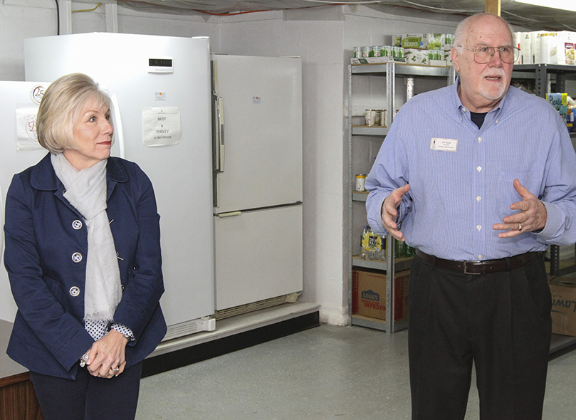 Amy Krysiek, left, and Leo Payne are co-presidents of the St. Vincent de Paul Society (SVdP) at St. John Neumann Church, Lilburn. In the background are three of the SVdP food pantry’s five freezers, which hold frozen meat, produce, and bakery goods that come from St. Vincent de Paul Georgia, as part of its Food Recovery and Distribution Program. Photo By Michael Alexander