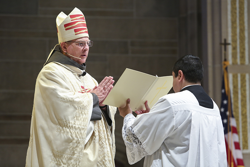 Archbishop Gregory J. Hartmayer, OFM Conv., left, accepts pastoral responsibility and care for the people of the Atlanta Archdiocese during the rite of canonical possession. It took place during his May 6 Mass of Canonical Installation at the Cathedral of Christ the King, Atlanta. Photo By Michael Alexander