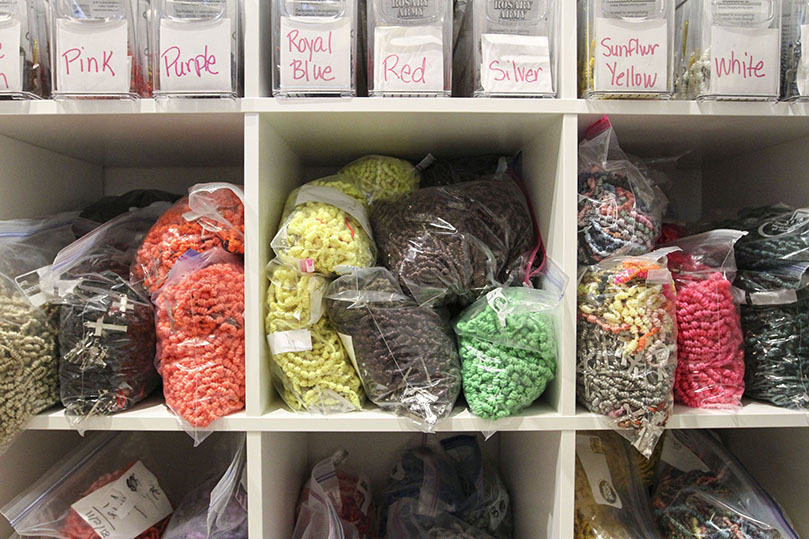 Completed all-twine knotted rosaries and supplies for making them are carefully arranged and stored in a closet cubby at the Willits’ home. Photo By Michael Alexander