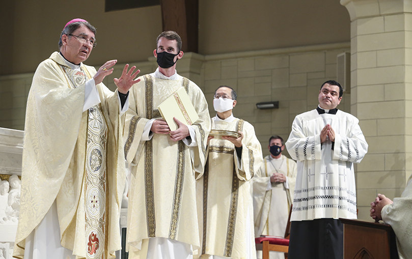 Archbishop Chistophe Pierre, far left, apostolic nuncio to the United States, shares some remarks about the pallium before he places it over the head of Archbishop Gregory J. Hartmayer, OFM Conv. Looking on in the foreground (l-r) are assisting deacons Rev. Mr. Paul Nacey and Rev. Mr. Hung V. Huynh and master of ceremonies Father Gerardo Ceballos-Gonzalez. Photo By Michael Alexander