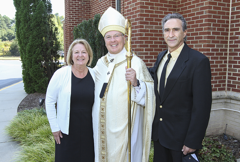 Archbishop Gregory J. Hartmayer, OFM Conv., took photos after the special Mass with a number of friends, including longtime members of St. Philip Benizi Church, Kathy and Mark Cirincione. Archbishop Gregory J. Hartmayer, OFM Conv., was pastor of the Jonesboro parish for 15 years. Photo By Michael Alexander