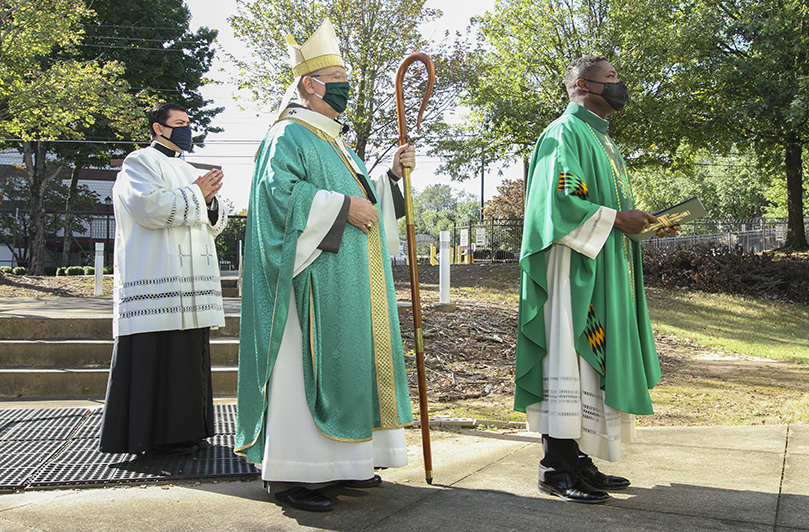 (L-r) Father Gerardo Ceballos-Gonzalez, master of ceremonies, Archbishop Gregory J. Hartmayer, OFM Conv., and Father Urey Mark, Lyke House chaplain and director, join the entrance procession. The Oct. 18 Mass marked the very day, 21 years ago, when the late Archbishop John F. Donoghue dedicated the Catholic Center. The sacraments of baptism and confirmation were also extended to three catechumens and one candidate during the liturgy. Photo By Michael Alexander