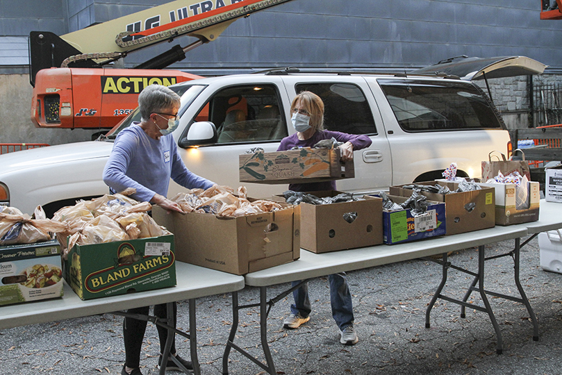 Barbara Hudson, left, and Karen McLean unload food items and other supplies. The women, two of the four volunteers from Peachtree City United Methodist Church, were on hand for the Central Night Shelter at the Shrine of the Immaculate Conception, Atlanta. For 25 years volunteers at Peachtree City United Methodist Church have worked the first and last week of the shelter, which operates annually from November 1 to March 31. Photo By Michael Alexander