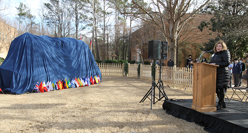 Holy Spirit Church parishioner Carolyn Johnson shares some information about the “Angels Unawares” sculpture and its artist, Timothy Schmalz, prior to its unveiling. Johnson and her husband Neil are co-chairs of the Georgia Chapter of Patrons of the Arts in the Vatican Museums, one of the sponsors of the sculpture’s Atlanta visit. Photo By Michael Alexander