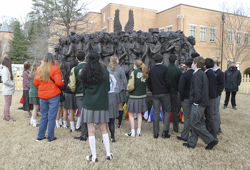 Holy Spirit Preparatory School students and adults get a close-up look at the “Angels Unawares” sculpture. Photo By Michael Alexander