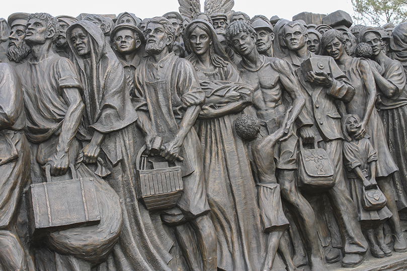 The church’s teachings on immigration are reflected in the “Angels Unawares” sculpture that depicts more than 140 immigrants over different periods in history. The immigrants are closely packed on a boat with the Holy Family. The sculpture will be on display in the upper school quad at Holy Spirit Preparatory School, Atlanta, until Feb. 3. Photo By Michael Alexander