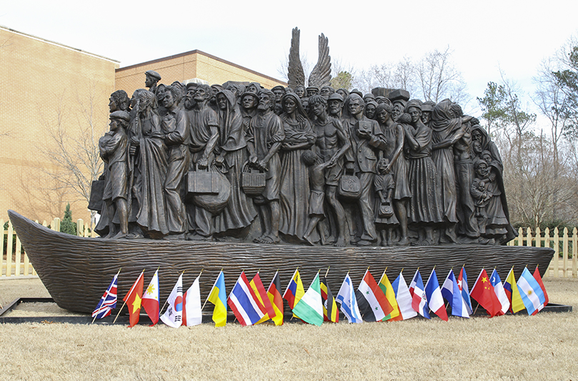 The bronze “Angels Unawares” sculpture is 20 feet long and weighs 3.5 tons. It’s a second casting of the one that was originally commissioned by Pope Francis and handcrafted by Canadian artist Timothy Schmalz. Although the original casting is displayed in St. Peter’s Square, this one will have a permanent place on the campus of the Catholic University of America, Washington, D.C. Photo By Michael Alexander