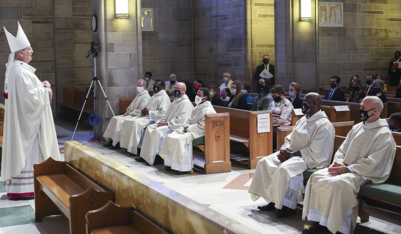 Archbishop Gregory J. Hartmayer, OFM Conv., left, shares some closing remarks of appreciation with the congregation and the new deacons. Six men were ordained to the permanent and one man was ordained a transitional deacon, Feb. 6, at the Cathedral of Christ the King, Atlanta Photo By Michael Alexander