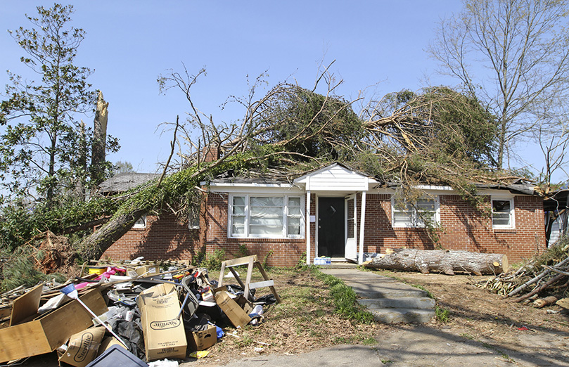 The March 25 EF-4 tornado caused two trees, one on the front and one on the back, to crash onto the roof of this house on Pinson Street. Nearly 1,800 of Newnan’s homes had significant damage, 120 homes are unlivable and 70 homes are completely destroyed. Photo By Michael Alexander