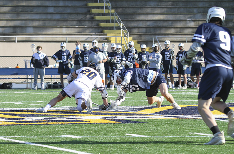 Marist School senior William Hudak (#20) successfully faces off against his Pace Academy opponent to start the April 22 lacrosse match, the final regular season game for each team. Photo By Michael Alexander