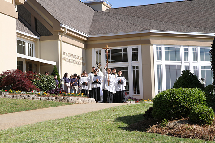 Altar servers lead a procession from St. Catherine of Siena Church to the Kennesaw parish school, as they are immediately followed by the real presence of Jesus in the Eucharist. Photo By Michael Alexander