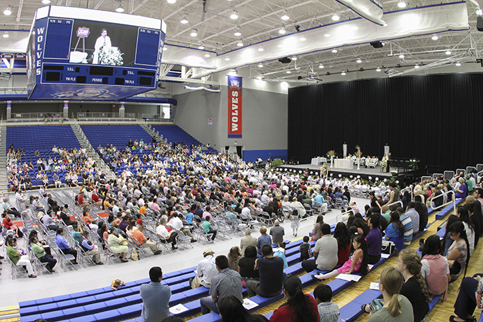 Father Rafael Carballo, pastor of Our Lady of Perpetual Help Church, Carrollton, delivers his homily during a May 1 Mass, which brought the entire congregation together in prayer for one Mass. Photo by Michael Alexander