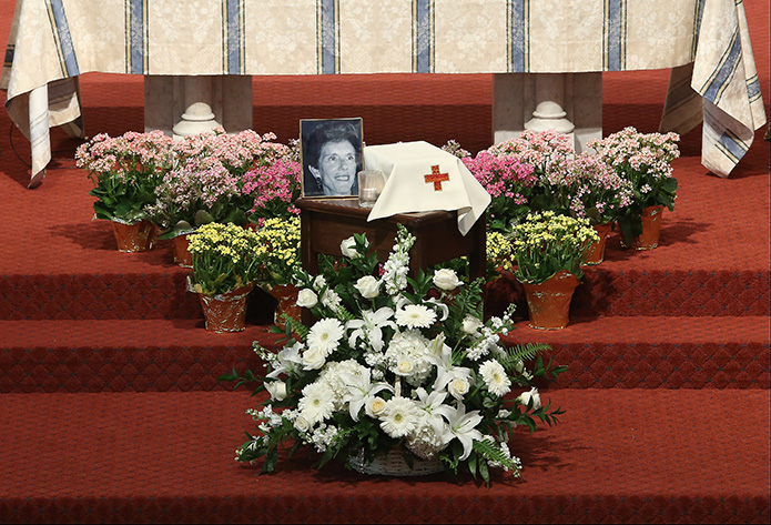 A photograph of Katie Bashor is displayed near the altar at the Shrine of the Immaculate Conception, next to a votive candle and the pall-covered container holding her cremated remains. The April 23 celebration of her life took place at the downtown Atlanta parish where she was a member for over 30 years. Photo By Michael Alexander