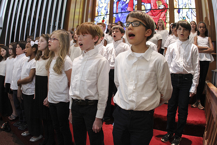 Thirty-five members of the Fernbank Elementary School fifth grade chorus, under the direction of Robin Ferguson, and accompanied on the organ by Shrine director of music Dónal Noonan, sing the post Communion hymn “Seasons of Love.” Photo By Michael Alexander