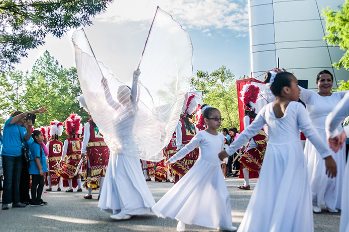 Twenty-year-old Jennifer Mondragon, left, depicts a graceful angel as she performs with her younger dance companions from St. Patrick Church, Norcross. Photo By Thomas Spink