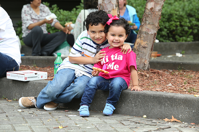 Seven-year-old Alexander Mozqueda and his 2-year-old sister Isabella sit outdoors at the convention center after the ADORE track for children and before the closing Mass. The Newnan parishioners of St. George Church were accompanied by their mother Sara. Photo By Michael Alexander