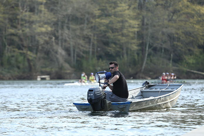 Varsity women’s coach Jason Berric observes some rowers as they race along the Chattahoochee River. Berric, a native of Orlando, Fla., is in his second season of coaching at the St. Andrew Rowing Club. Photo By Michael Alexander