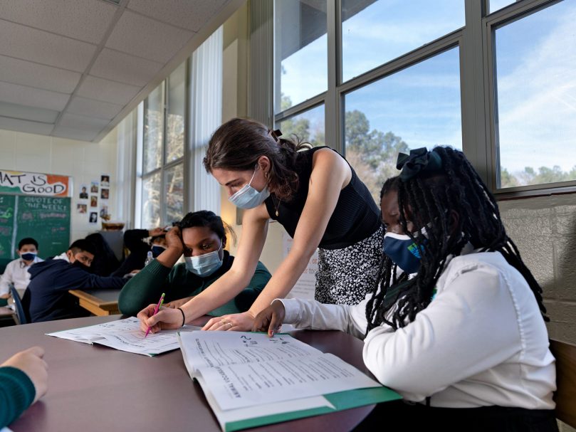 ACE Fellow Olivia Anderson helps her students a St. Peter Claver Regional School. The program, coordinated through the University of Notre Dame, places teachers in underserved Catholic schools.